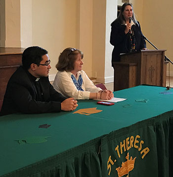 St. Theresa School Vice Principal Gloria Marti welcomes eighth-grade students to the alumni induction luncheon as Father Phillip Tran and Vice Principal Nancy Capper look on.