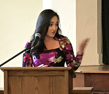 Liane Morejon, WPLG Channel 10 reporter and a class of 2000 St. Theresa alumna, speaks to eighth-grade students at the alumni induction luncheon.