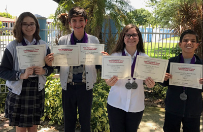 Members of Immaculate Conception School's WICS Celtic News team pose with the certificates and medals they received from the Journalism Education Association.