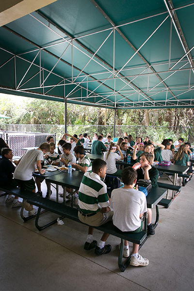 Students at Mary Help of Christians School in Parkland currently eat lunch outdoors. The Parkland school broke ground May 24 for a new Parish & Student Center which will replace the current temporary classrooms and outdoor cafeteria space.