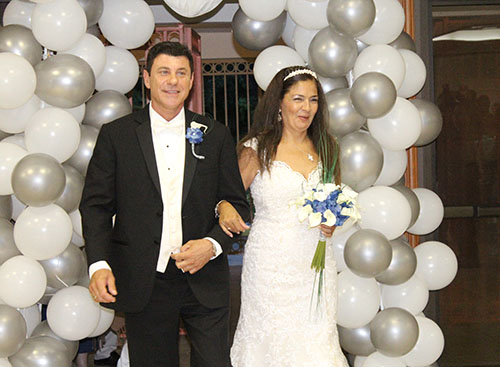 Let's welcome the bride and groom: Calogero "Lillo" Tirone and his wife, Marlene Esguerra, enter their wedding reception at St. Martha's parish hall.