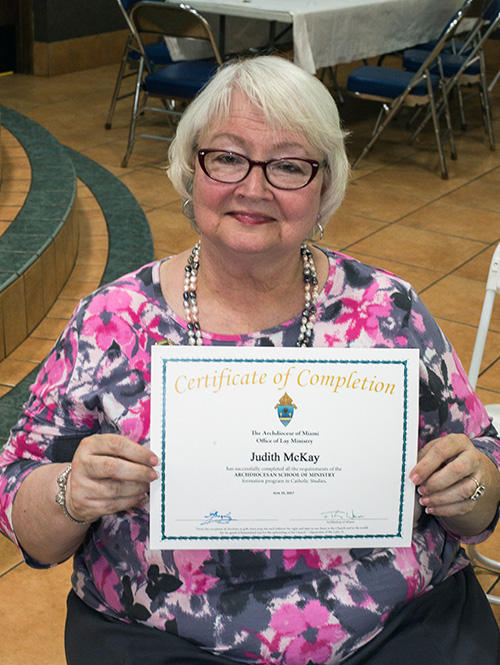 Judith McKay holds up her certificate of completion of the two-year School of Ministry.