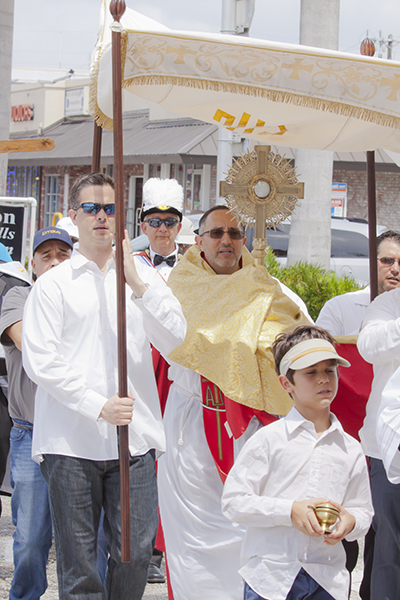 Father Julio De Jesus, parochial vicar at Nativity Church in Hollywood, carries the Blessed Sacrament as marchers pray and walk seven times around “A Woman's Center," an abortion facility located on Hollywood Boulevard, during the "Jericho Walk" June 11.
