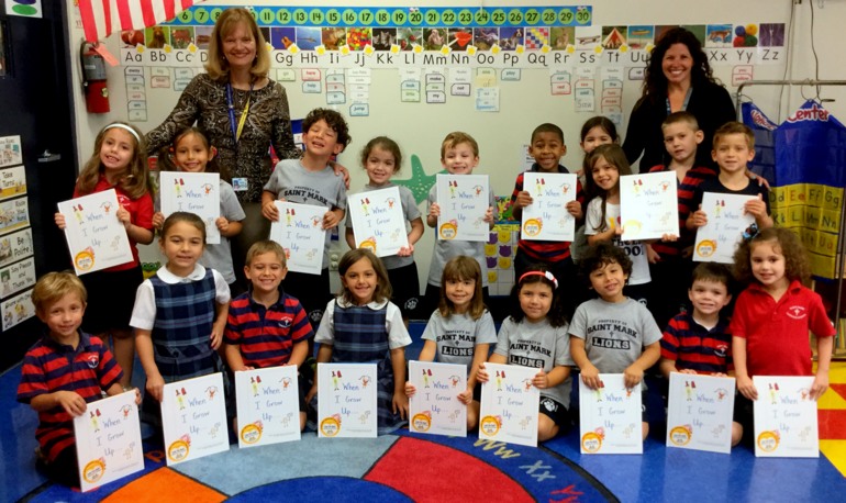Pre-K 4 students at St. Mark's School show the book they produced on "When I Grow Up."