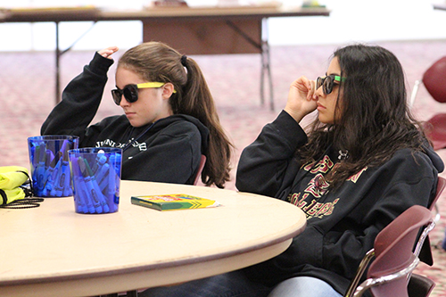 We all wear shades sometimes: With sunglasses on, Karina Czubkowski and Stephanie Melendez listen to a presentation on perspective.