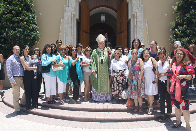 Domestic workers and labor representatives pose with Archbishop Thomas Wenski after the Mass celebrated June 25 at St. Mary Cathedral to recognize domestic workers in Miami-Dade County.