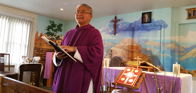 Father Rafael Bercasio speaks to tourists gathered for Sunday Mass at El Cristo Rey Chapel in the Grand Canyon, the only Catholic parish located inside a national park.