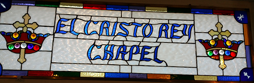 Stained glass window displays the name of El Cristo Rey Chapel, located in Grand Canyon Village, within the national park.