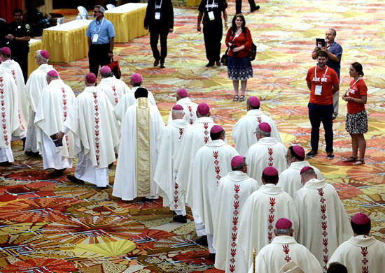 Clergy file into the convention hall July 4 for a Mass of Sending: Mission and Going Forth during the Convocation of Catholic Leaders in Orlando. The four-day convocation gathered 3,500 leaders, lay and clergy alike, to discuss issues and strategies.