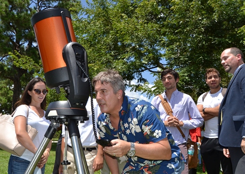 Professor David Quesada resets the telescope to follow the track of the sun as the moon eclipses it.