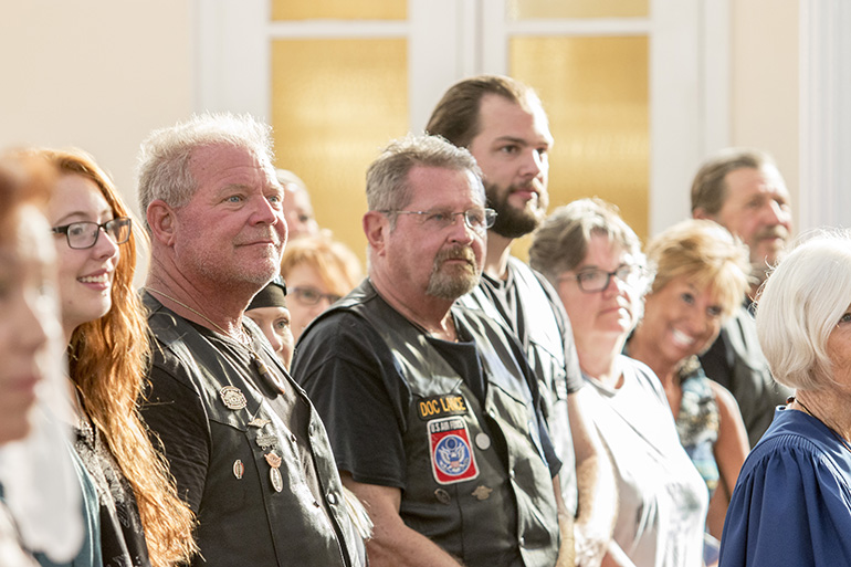 Bear Woznick, left, and some of his "Long Ride Home" crew, "Doc" Lance Maki and Tony Orband, take part in Sunday Mass Aug. 6 at the Basilica of St. Mary Star of the Sea in Key West. The "Long Ride Home" episodes featuring Archbishop Thomas Wenski will begin airing on EWTN in March.