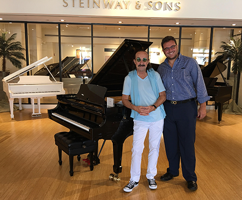 Argentine pianist Raul Di Blasio, left, poses with Luis Cuza, Church of the Little Flower's associate director of music, at a Steinway & Sons store. Di Blasio will headline the first Steinway-Little Flower Concert series performance, set for Sept. 30 at 8 p.m. in the parish's Comber Hall.