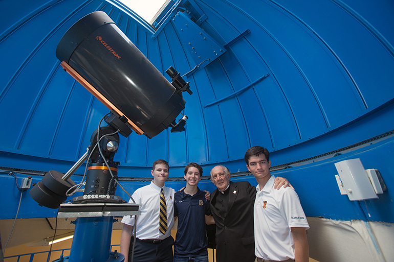 Kevin Galego, 17, Danny Jimenez, 14, Jesuit Father Pedro Cartaya, and alumnus Michael Cairo, 19, pose for a photo in Belen Jesuit Observatory with its 16" telescope. Belen is one of only a few South Florida schools with an observatory, and the only one in the U.S. with a 16” telescope with a CCD camera for astrophotography.