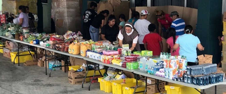 Parishioners and Servants of the Pierced Hearts of Jesus and Mary prepare a food distribution at San Juan Chapel in Florida City.