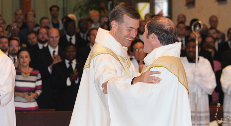 Msgr. David Toups, rector of St. Vincent de Paul Regional Seminary in Boynton Beach, congratulates Father Martin Dunne III moments after he becomes a new priest of the Diocese of Palm Beach. Father Dunne spent years in study, formation and discernment at the seminary in preparation for the priesthood.