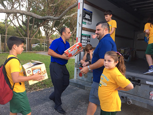 Helping out in "little ways," St. Theresa School students and parents fill a truck with relief supplies they would later deliver to residents of deep South Dade and the Florida Keys.