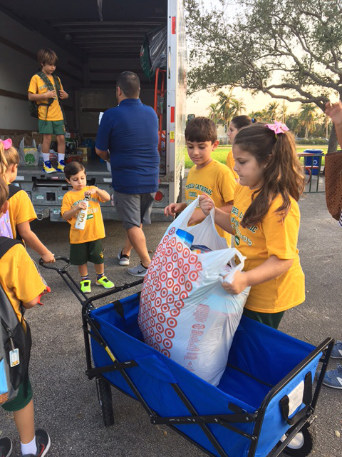 Helping out in "little ways," St. Theresa School students and parents fill a truck with relief supplies they would later deliver to residents of deep South Dade and the Florida Keys.