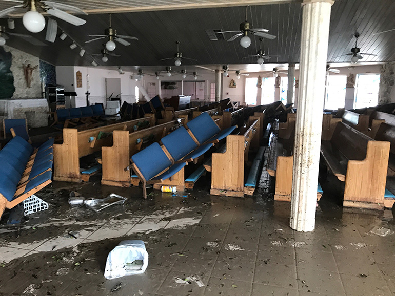 View inside the church of St. Peter the Fisherman in Big Pine Key shows the pews tossed by wind and water from Hurricane Irma. It was the archdiocesan facility most devastated by the storm's passage through South Florida. The church is now unusable and the parish remained without air conditioning, phone or internet as of Sept. 20. Parochial administrator Father Jesus "Jets" Medina will use the second floor of the ministry center as parish office, chapel and religious education classroom for now.