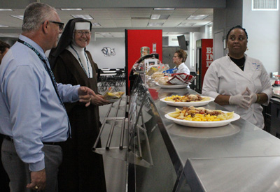 Filippo Baglio, director of operations at Archbishop Coleman Carroll and a native Italian, teases Sister Margaret Ann for not choosing the pasta for lunch.