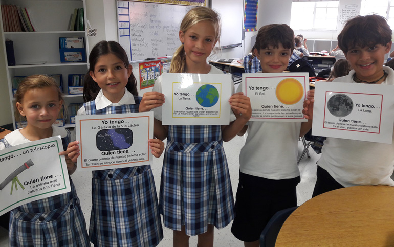 Third graders Ava Crowley, Alaia Medellin, Paola Ducharne, Filipe Da Silva, Gustavo Prego pose with their "Yo tengo" ("I have") solar system signs that they used during a Science class taught in Spanish. St. Agnes Academy is participating in the Spanish Immersion TWIN-CS Program.