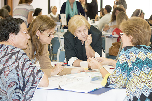 Catechetical leaders discuss the new curriculum at the June meeting where it was introduced.