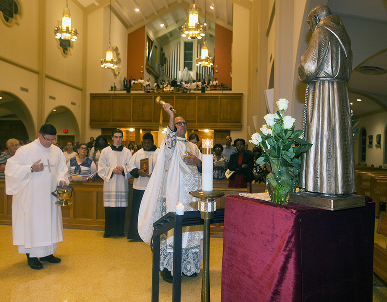 Father Christopher Marino blesses the statue of St. Padre Pio which was donated to St. Mary Cathedral.