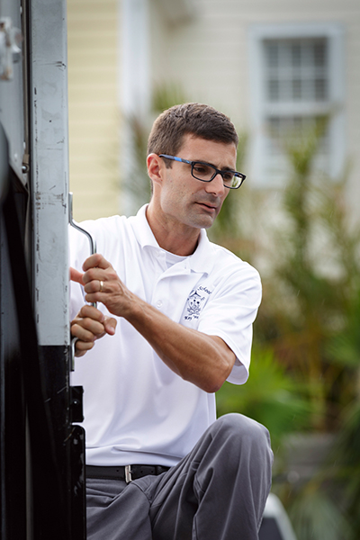 Robert Wright, principal of the Basilica School of St. Mary Star of the Sea in Key West, watches as volunteers from the Archdiocese of Miami deliver emergency supplies Sept. 26. The donated items had been collected at a dozen Catholic schools and parishes in Miami following the storm and left at hard-hit sites from Key Largo to Key West.