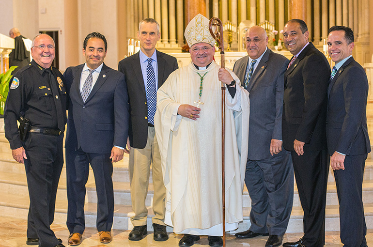 Auxiliary Bishop Peter Baldacchino poses with law enforcement officers after celebrating the 15th annual Blue Mass at St. Patrick Church, Miami Beach, Sept. 29. From left: Sunny Isles Police Chief Fred Maas; David Jaramillo, president of the Hispanic Police Officers Association; Peter Newman, chaplain emeritus of the Miami-Dade Police Benevolent Association; John Rivera, Miami-Dade PBA president; Luis Fuste; and Carlos Vasquez.