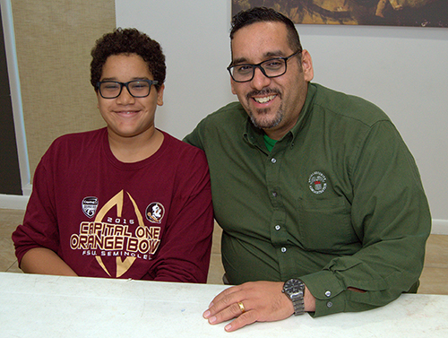 Frank Medina is in charge of lectors at Our Lady Queen of Martyrs Church. Son Anthony, a sixth-grader, is already a lector and altar server.