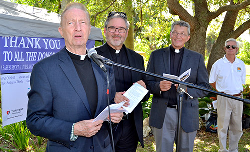 Father Pat O'Neill, at the microphone, introduces the dedicatory prayer for the new labyrinth at MorningStar Renewal Center. Next to him, from left, are Lutheran ministers Walter Still and John Mocko, and Commissioner James McDonald of Pinecrest.