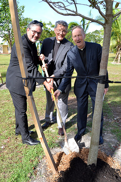 Lutheran and Catholic ministers help to dedicate a mahogany tree during the dedication of the new labyrinth at MorningStar Renewal Center in Pinecrest. From left are ministers Walter Still and John Mocko of the Evangelical Lutheran Church in America, and Father Pat O'Neill of the archdiocese.