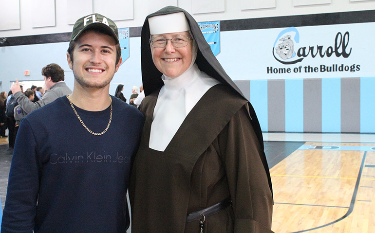 The singer who wrote about the chainsaw nun: Dylan Schneider poses with Sister Margaret Ann Laechelin at Archbishop Coleman Carroll High's gym on Oct. 5 where he performed a song he wrote about the sister's claim to fame with a chainsaw.