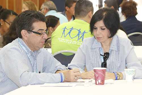 Antonio De Noriega and Otilia Freitas of Nativity Parish in Hollywood reflect on questions posed by speakers during the V Encuentro archdiocesan celebration, held Oct. 7 at Immaculate Conception Church in Hialeah.