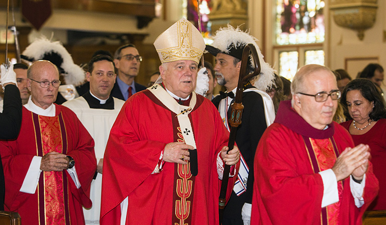 Archbishop Thomas Wenski follows Jesuit Father Eduardo Alvarez, Gesu's pastor, into the church at the start of the Red Mass.