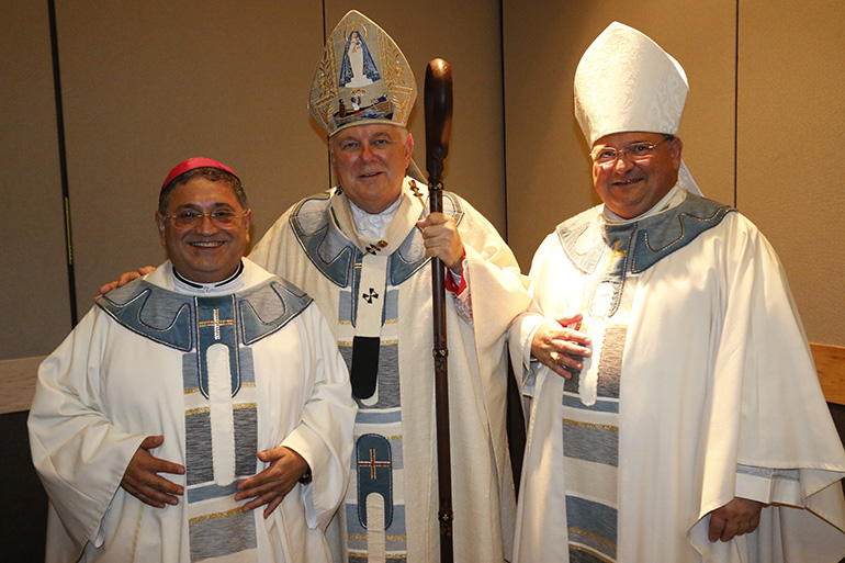 Archbishop Thomas Wenski poses with his auxiliary bishops, Bishop Peter Baldacchino (left) and newly appointed bishop-elect Enrique Delgado.