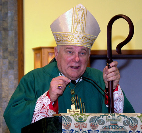 Archbishop Thomas Wenski, during the kickoff Mass for St. Helen Church's 50th anniversary, urges his listeners to stretch even more to welcome people to church.