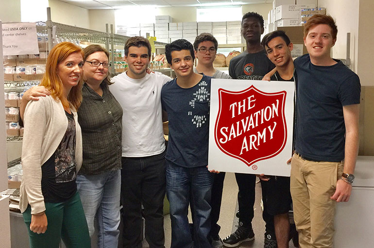 Members of the FIAT Club (Faith In Action Today) from Archbishop Edward McCarthy High School in Southwest Ranches pose after serving in the Salvation Army Pantry Oct. 16; from left: Julie Daligney, club moderator, Samantha Cattell, pantry coordinator at the Salvation Army, Austin Wallace, Alex Diener, Jesus Palenzuela, Jonathan Joseph, Victor Rodriguez, and Jack Loyello.