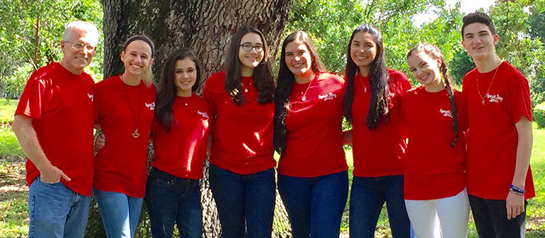 Campus ministry students from Archbishop Edward McCarthy High School pose with Chris Covone, far left, campus ministry director, after helping out at the confirmation retreat for eighth graders at St. Mark School in Southwest Ranches. From left: Lourdes Covone, Grace Villavisanis, Lindsey Millares, Maria Paola Ortega, Melissa Castaneda, Sarah Lynch, and Ian Lynch.