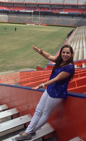 Florida Catholic newspaper freelancer and intern Christy Piña does the Florida Gator chomp at the Ben Hill Griffin Stadium, also known as "The Swamp." Piña is a senior studying journalism at the University of Florida.