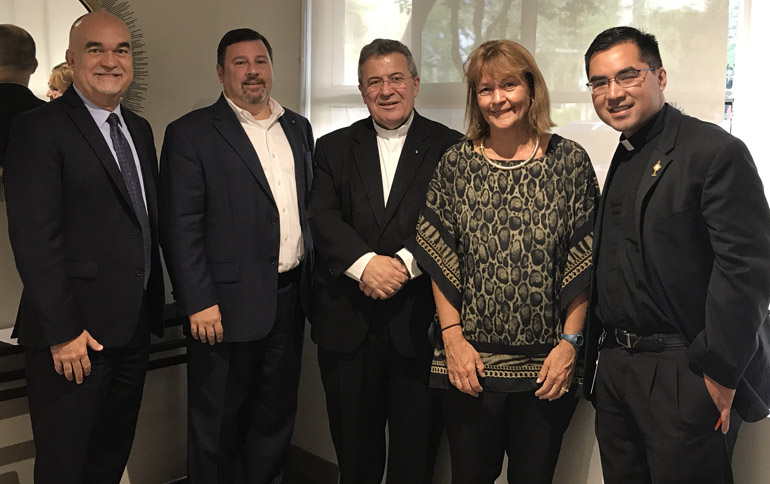 UM Catholic campus ministry suite in Pentland House at the University of Miami receives a visit from (left to right) Gilbert Arias, Assistant Vice President of Facilities for the University of Miami, Stephen Colella, archdiocesan cabinet secretary for parish life, Msgr. Tomas Marin, pastor of St. Augustine Church, Patricia Whitely, vice president of student affairs at the University of Miami, and Father Phillip Tran, Catholic Campus Minister at the University of Miami. The Archdiocese of Miami and the University of Miami collaborated in the efforts to establish a space and a priest on campus for Catholics.