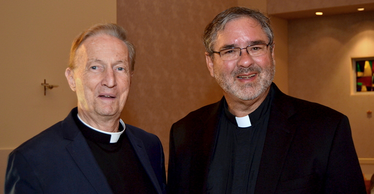 Two ecumenists chat after a dialogue for Reformation 500 earlier this year at St. Thomas University. From left are Father Pat O'Neill of the Archdiocese of Miami, and the Rev. Walter Still of the Evangelical Lutheran Church in America.