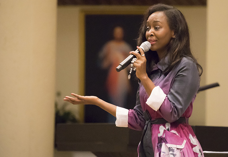 Holding a rosary, Immaculee Ilibagiza tells her story of faith, hope and forgiveness to the hundreds who came to see her at St. Bonaventure Church in Davie.