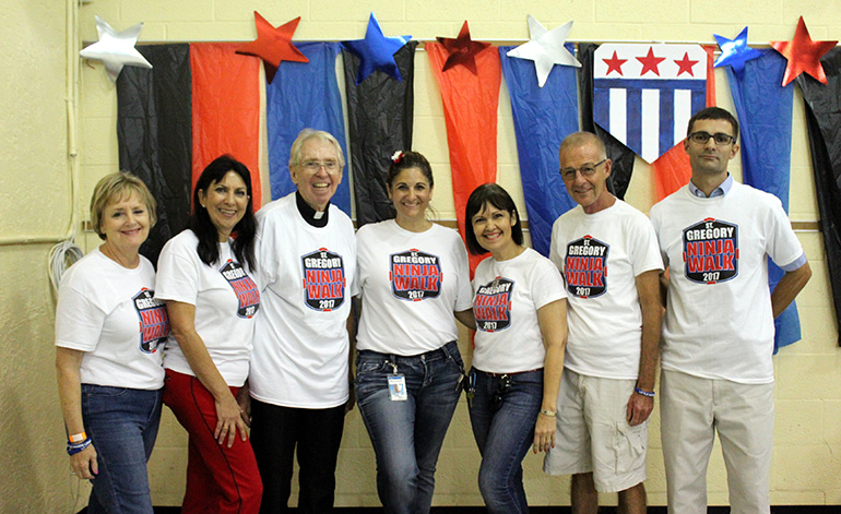 Pictured on the day of the walk-a-thon that donated half of the money raised to the Basilica School of St. Mary Star of the Sea, from left: Jan Bennings, Donna Wells, Father Michael Hoyer, St. Gregory's pastor, Carla Landron, walk-a-thon chair, St. Gregory School Principal Caridad Canino, and Father John Baker and Robert Wright, pastor and principal, respectively, of St. Mary Star of the Sea church and school.