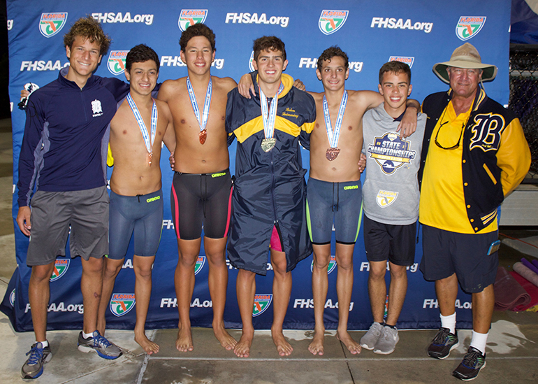 Belen swimmers Andres Wong, Hugo Marin, Hector Paz, Aitor Fungairino, Javier Saumell, and Ignacio Aguilar pose with their coach, Kirk Peppas.