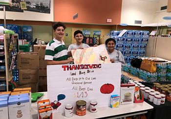 Mary Help of Christians eighth-graders advertise their Thanksgiving food drive at the neighborhood Publix.