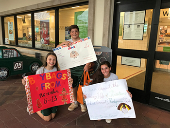 Mary Help of Christians eighth-graders advertise their Thanksgiving food drive at the neighborhood Publix.