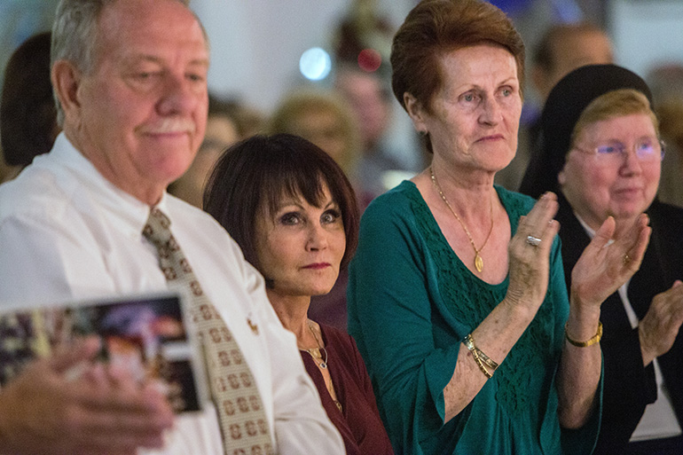 From left: Lex Norris, Justin Lex Norris' father, Lucy Vanpelt, Justin's mother, Josephine Oakley, a friend and fellow parishioner, and Sister Elizabeth Worley of the Sisters of St. Joseph, chancellor and COO for the archdiocese, sit in the front row of St. Matthew church during the organ dedication concert.