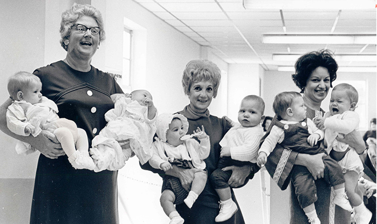 In this Florida Catholic file photo, members of the Catholic Welfare Bureau's adoption staff pose in 1958 with babies they placed for adoption. The Miami archdiocese recently relaunched its adoption program. The agency then known as the Catholic Welfare Bureau is now called Catholic Charities.