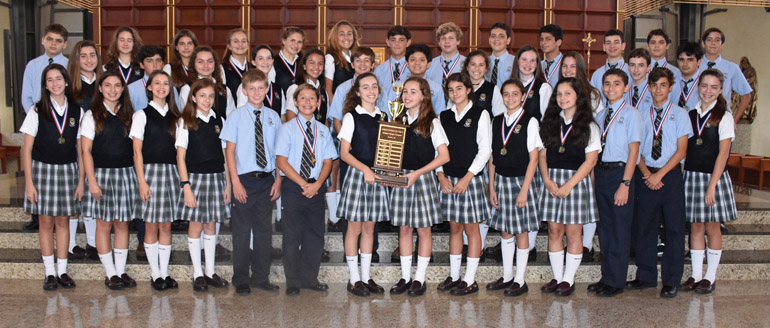 Scholastic students athletes from Epiphany School pose with the medals and first place trophy they won at the 39th annual Christopher Columbus Scholastic Olympics.