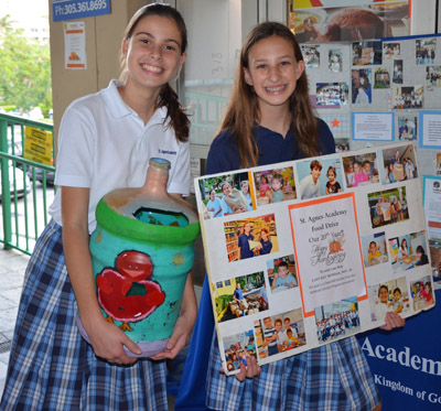 St. Agnes Academy eighth graders Victoria Trap and Ella Kuppers promote the Thanksgiving Food Drive.